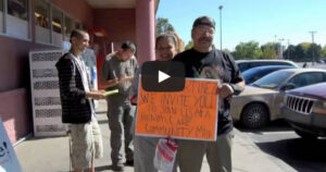 video still of people holding up signs